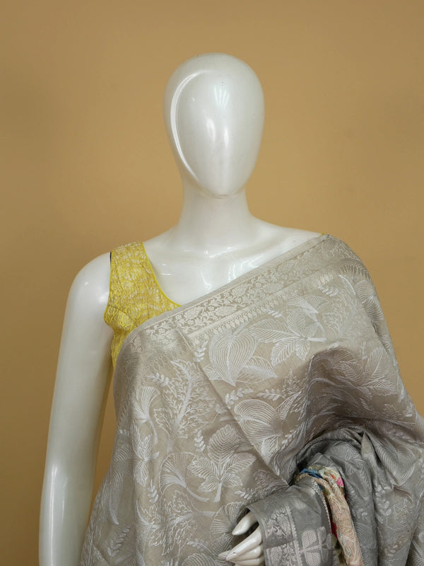 Grey designer saree with white floral embroidery, silver zari border and multicoloured embroidered roses