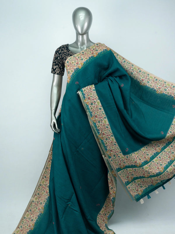 Teal green linen cotton saree with cream multicoloured floral border and black blouse