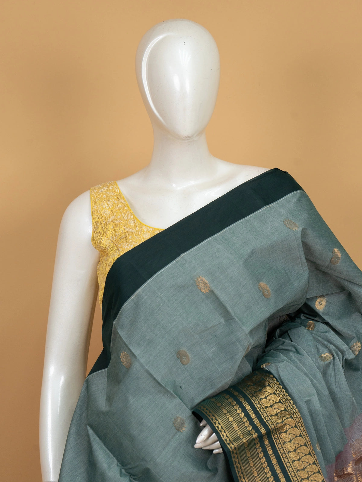 Sage green Chettinad cotton saree with teal gold zari contrast border and paisley buttas
