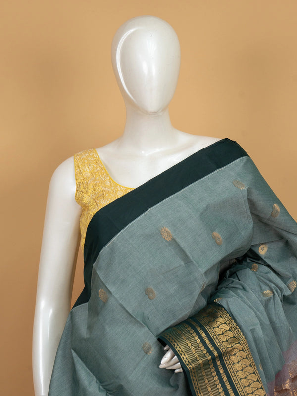 Sage green Chettinad cotton saree with teal gold zari contrast border and paisley buttas