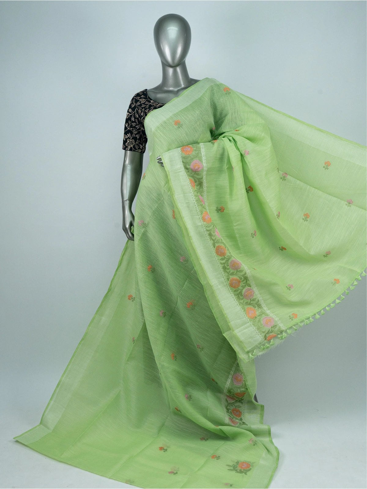 Light green linen cotton saree with silver zari border and multicoloured floral embroidery