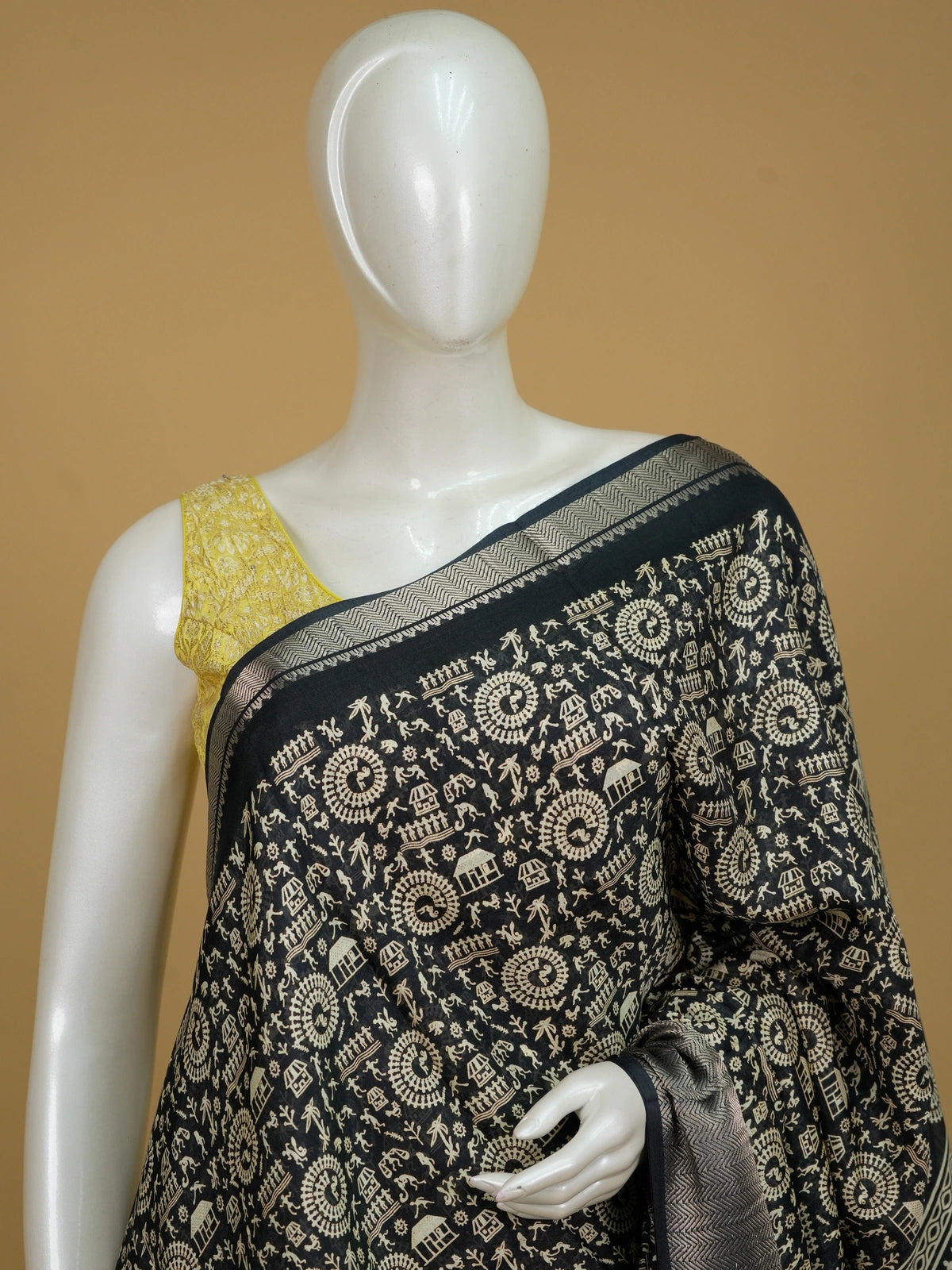Black designer saree with cream Warli tribal art print and silver zari chevron border