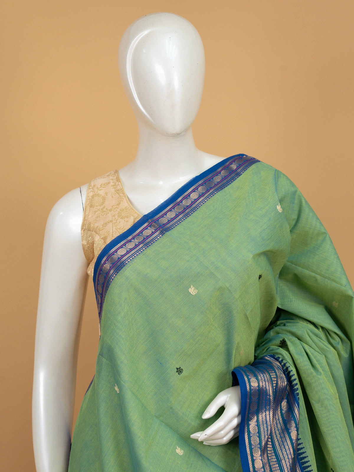 Green Chettinad cotton saree with contrast blue and gold zari temple border and scattered buttas