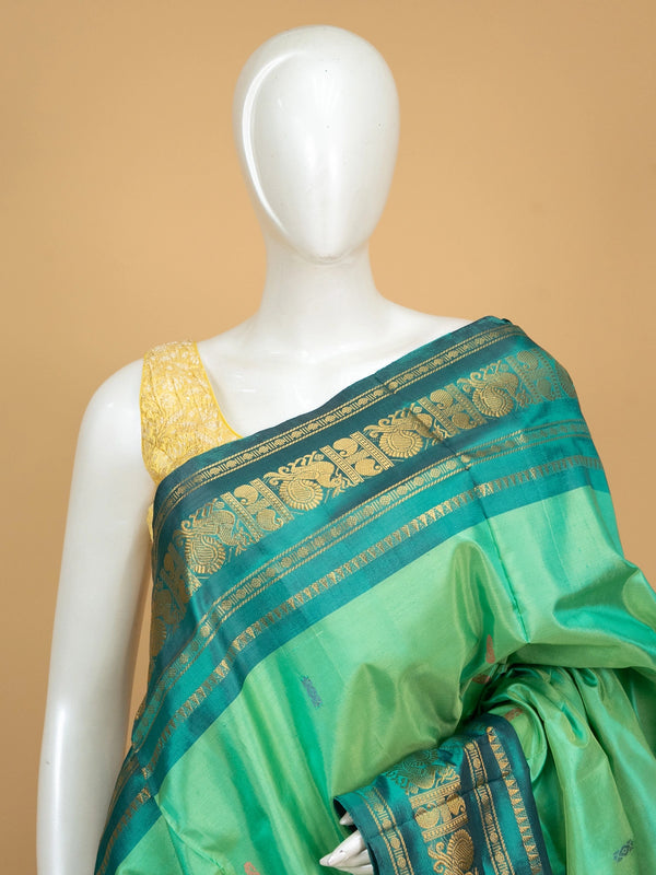 Green Banana Silk saree with teal gold zari peacock border and black striped pallu