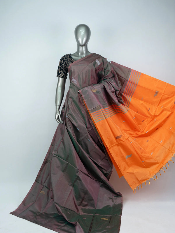 Grey and orange banana silk saree with dual-tone body, zari buttas and a striped contrast orange pallu