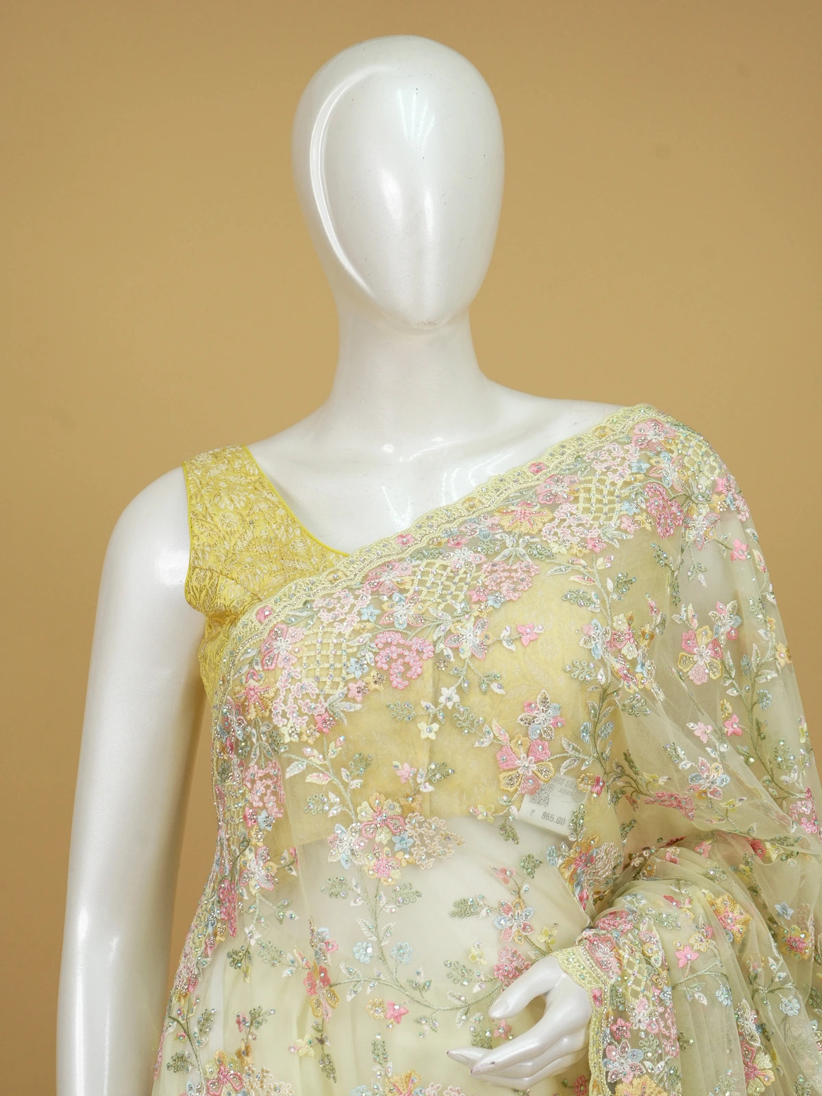 Lemon yellow net designer saree with pastel multicolour floral embroidery and scalloped border