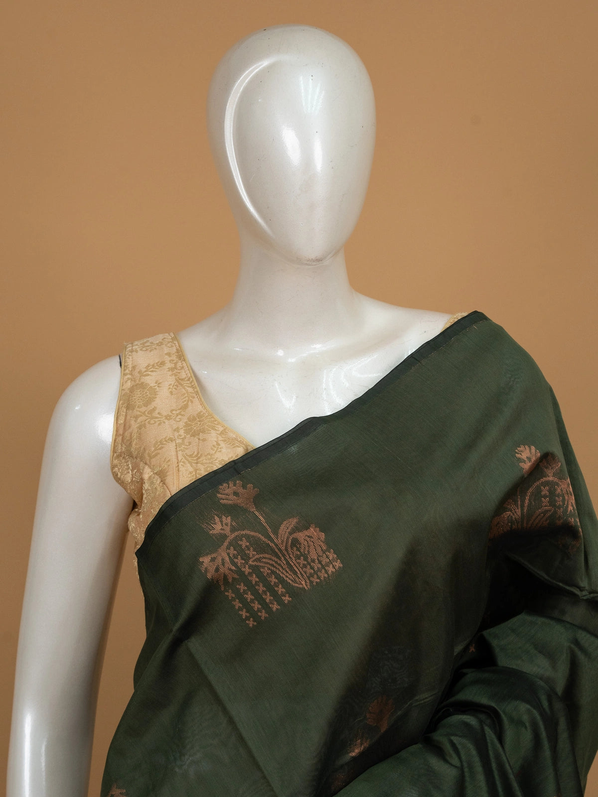 Dark green silk cotton saree with copper zari buttas and contrast maroon border and pallu