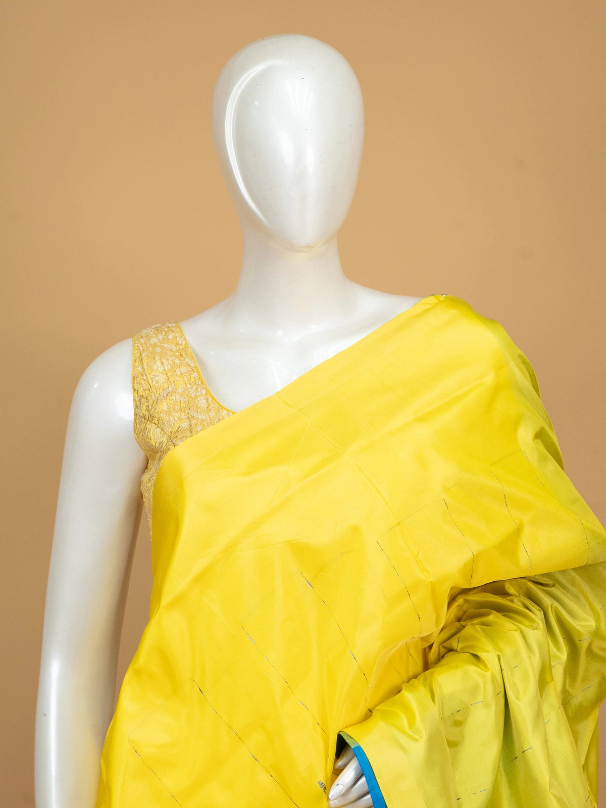 Yellow banana silk saree with contrast blue pallu, striped border and blue blouse