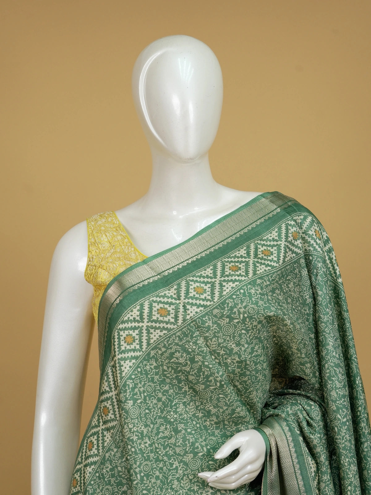 Sea green designer saree with cream tribal Warli print and gold zari border