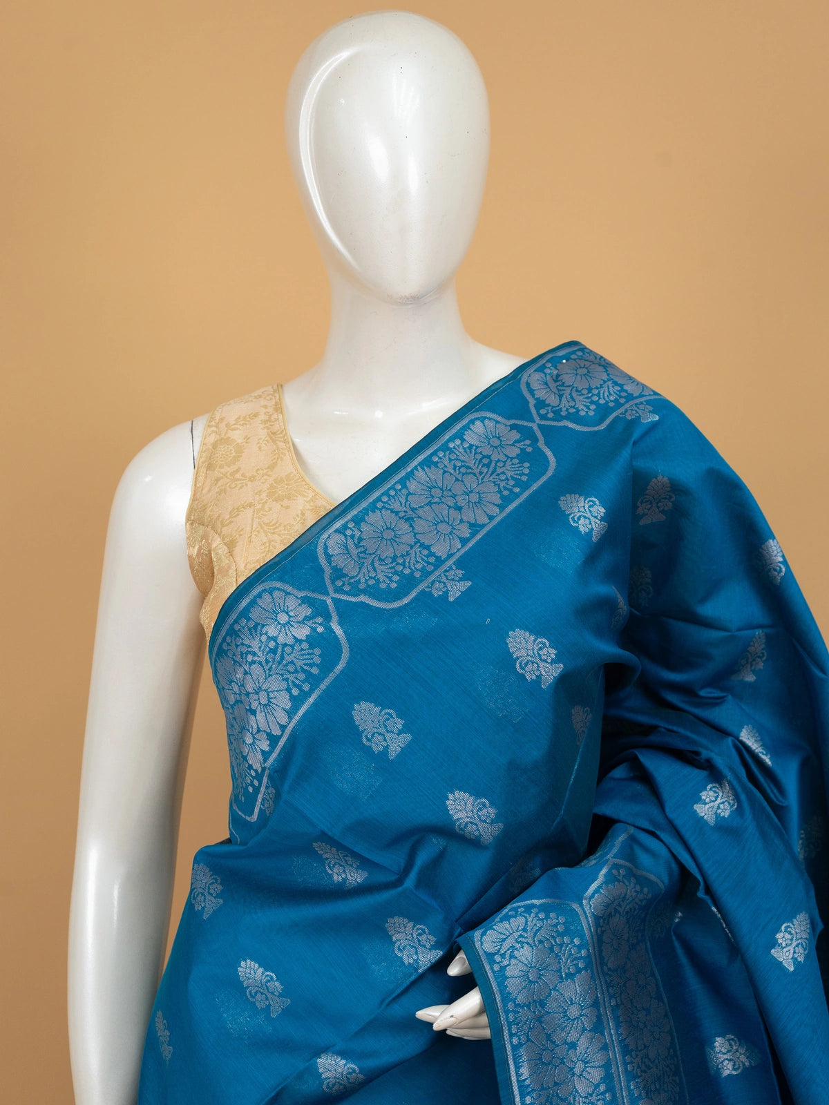 Peacock blue silk cotton saree with silver zari floral buttas and diamond-patterned border