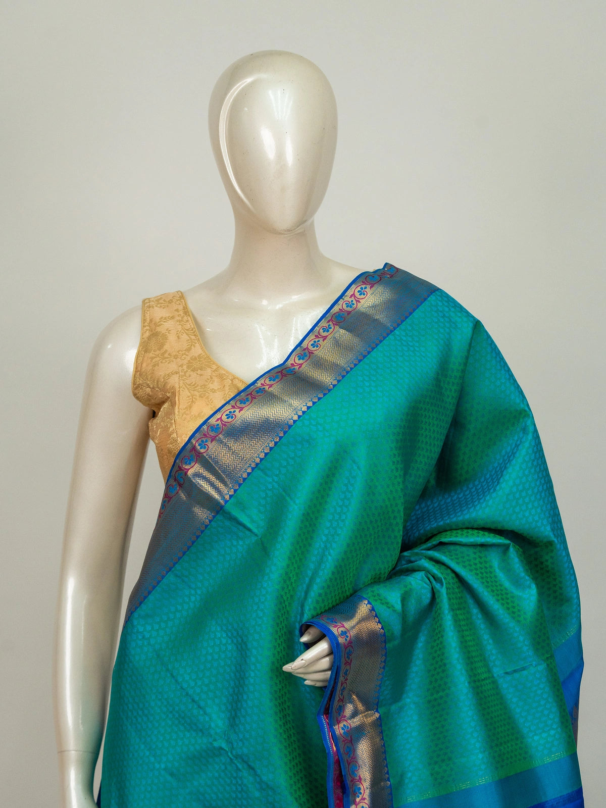 Teal green pure Kanchipuram silk saree with contrast blue and gold zari border and floral zari pallu