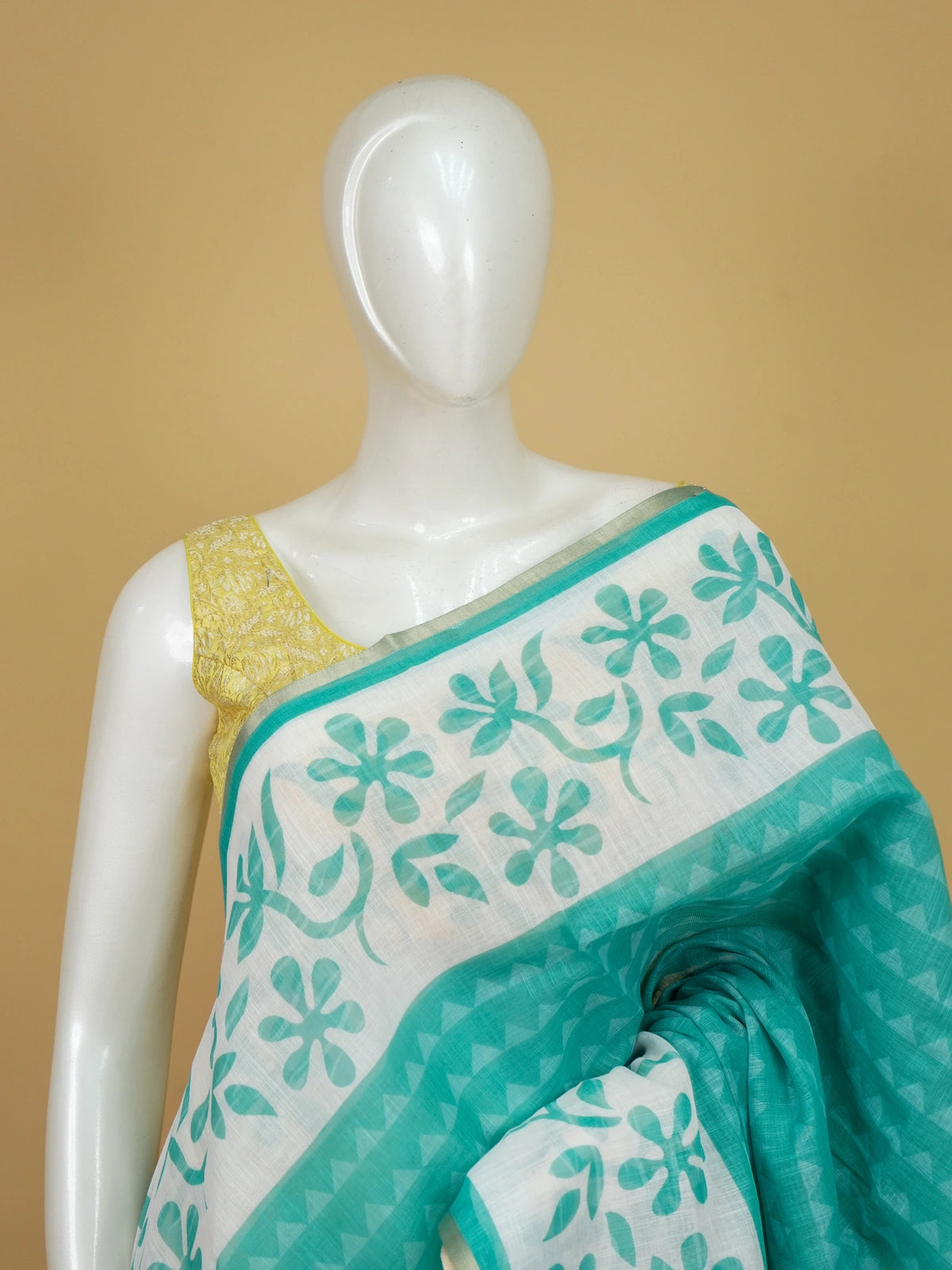 Teal and white floral printed linen cotton saree with gold border and matching blouse