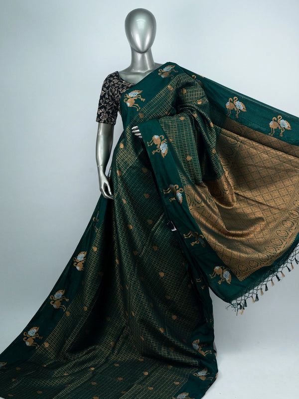 Bottle green semi raw silk saree with gold zari checks, yali motifs and contrast black embroidered blouse