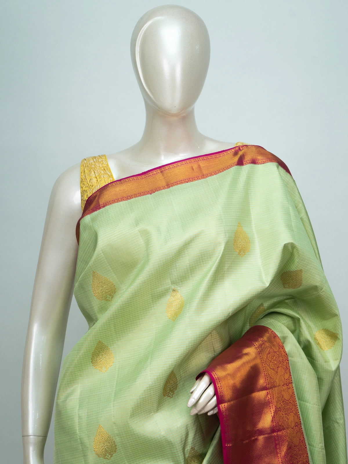Pastel green pure Kanchipuram silk saree with contrast pink gold zari border and brocade pallu