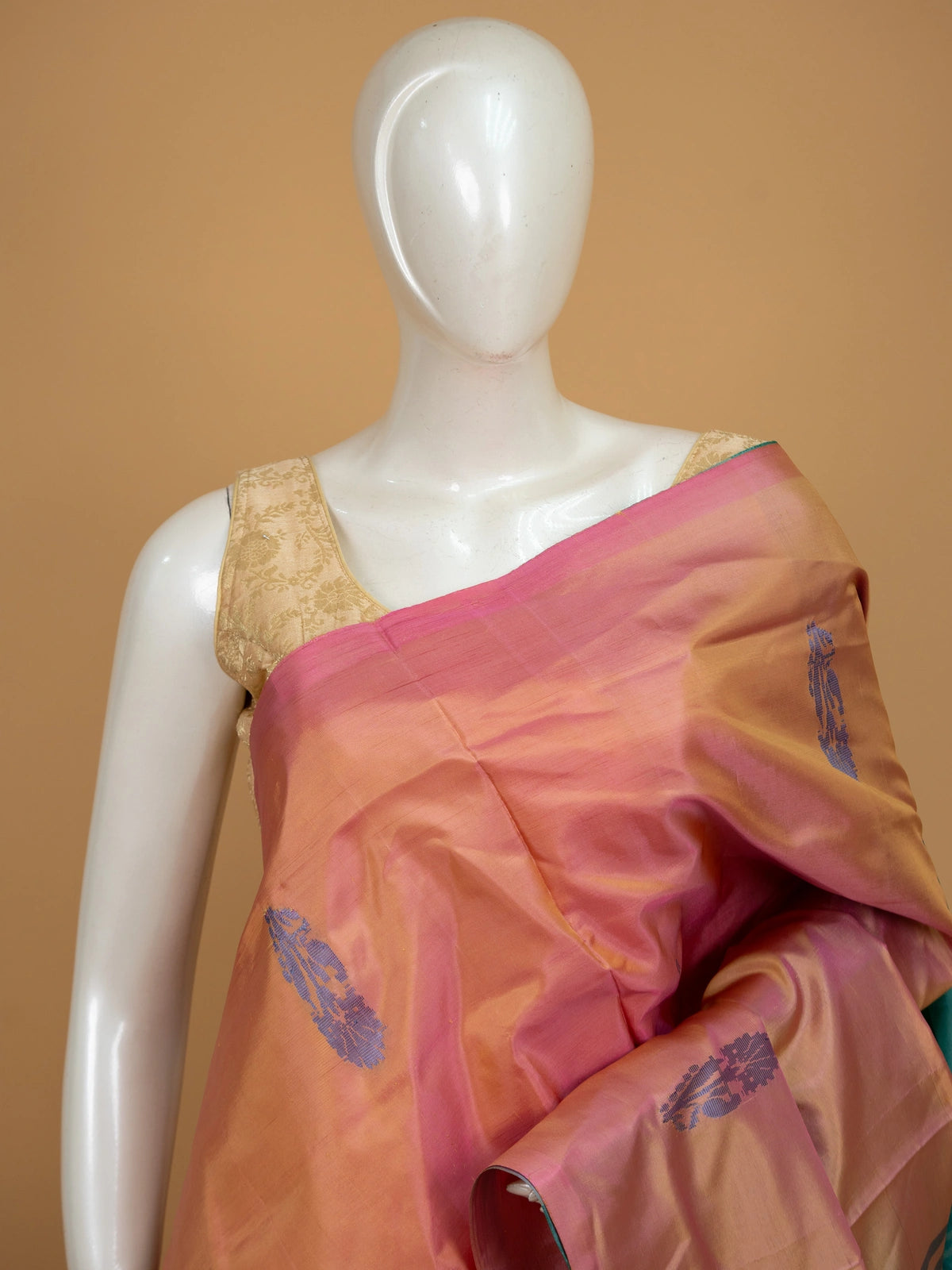Peach pink and teal green banana silk saree with gold zari buttas and contrast striped pallu