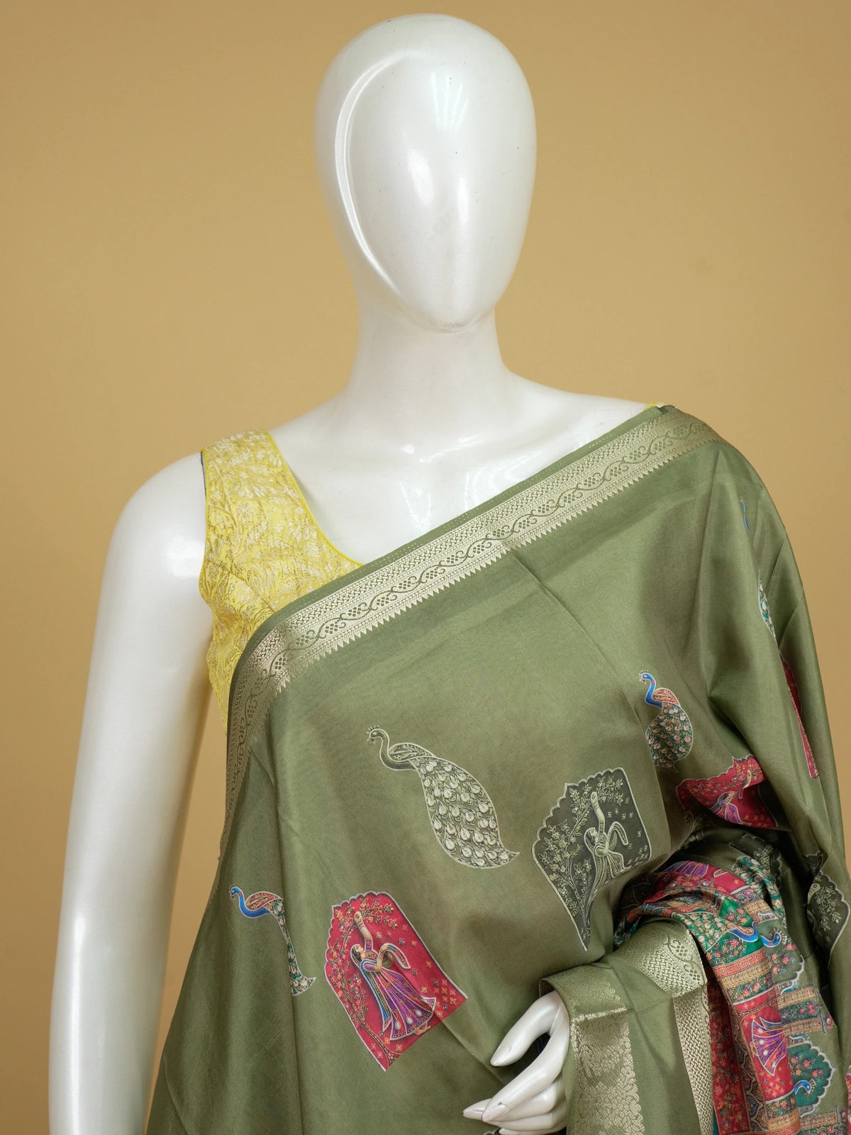 Olive green Dola silk saree with multicolour dancing lady and peacock prints and gold zari border