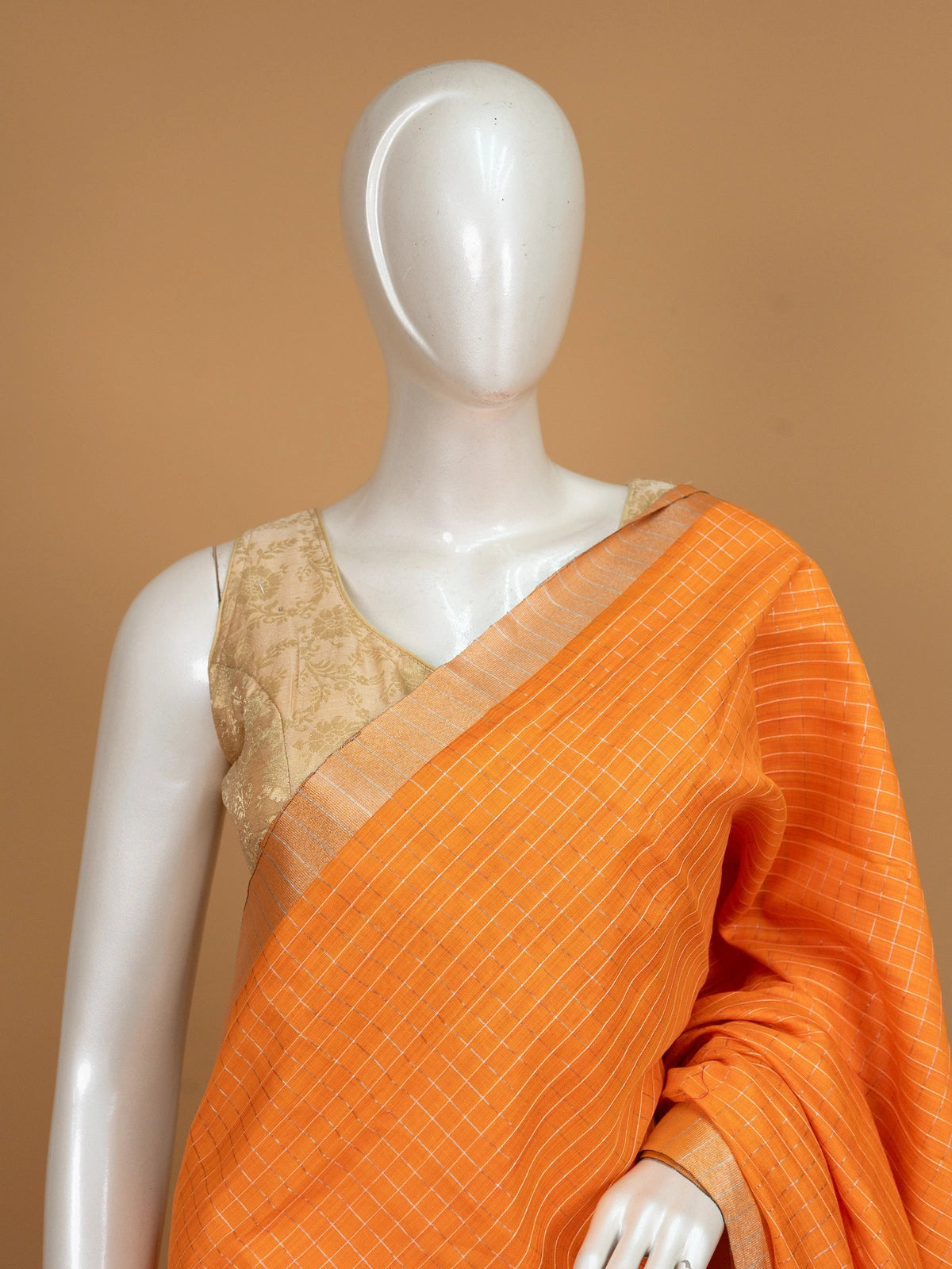 Orange linen cotton saree with white checks, contrast pink border with gold zari, and striped pink blouse