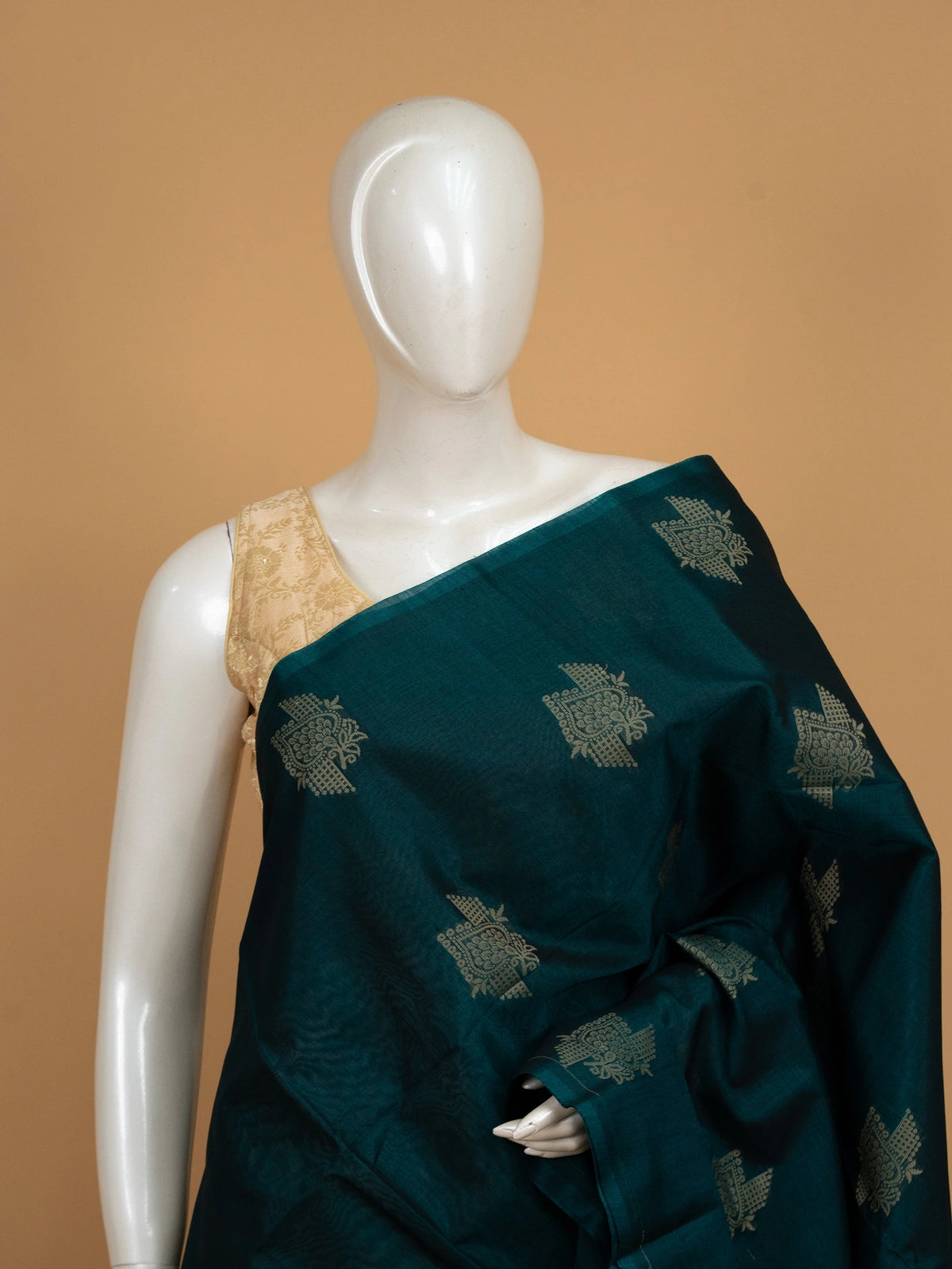 Teal green pure silk cotton saree with contrast maroon border, woven butta motifs, and geometric maroon pallu