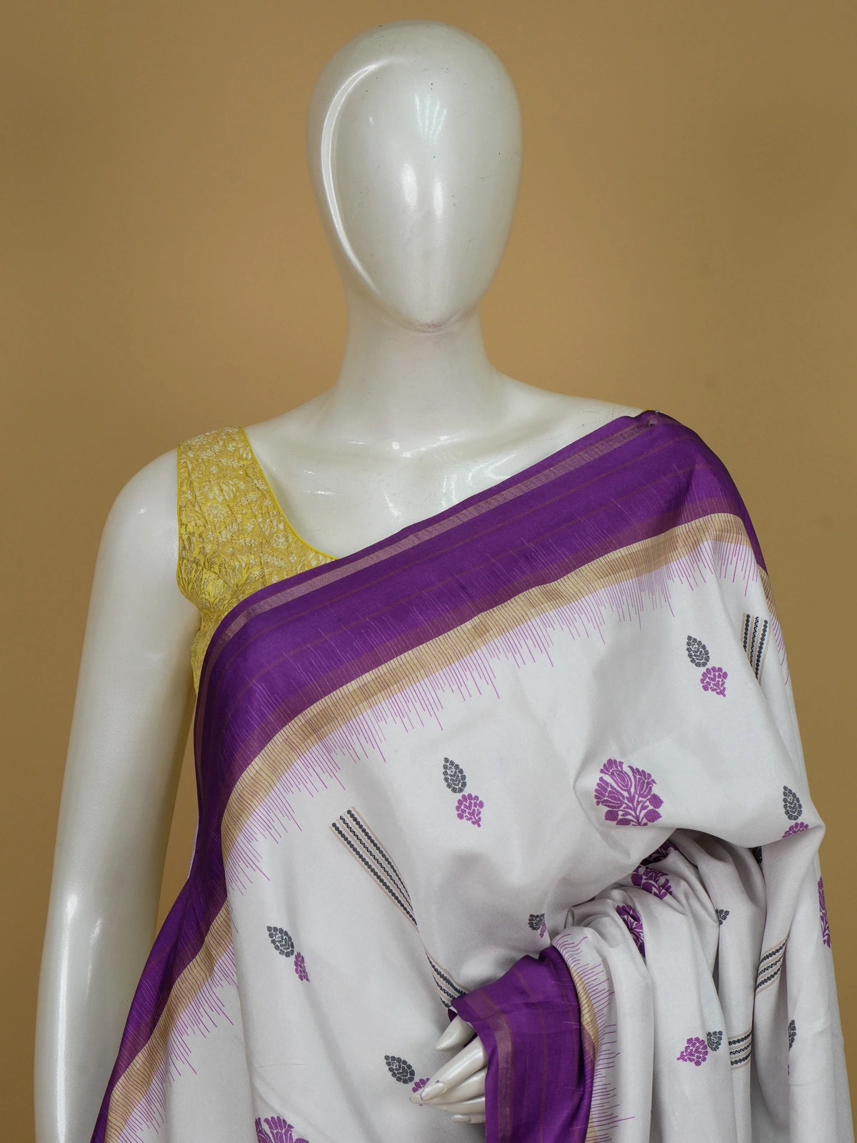Cream Dola silk saree with purple floral buttas, gold zari contrast border and patterned purple pallu