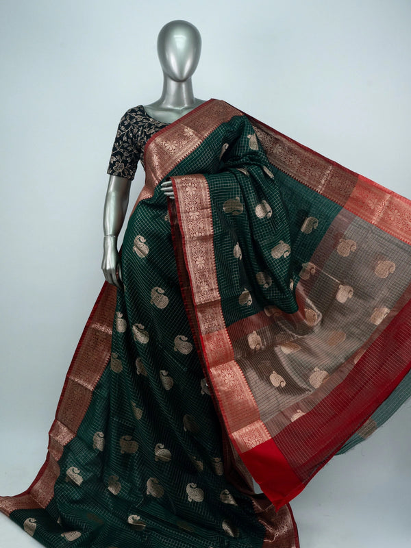 Dark green semi raw silk saree with red contrast zari border and paisley butta motifs