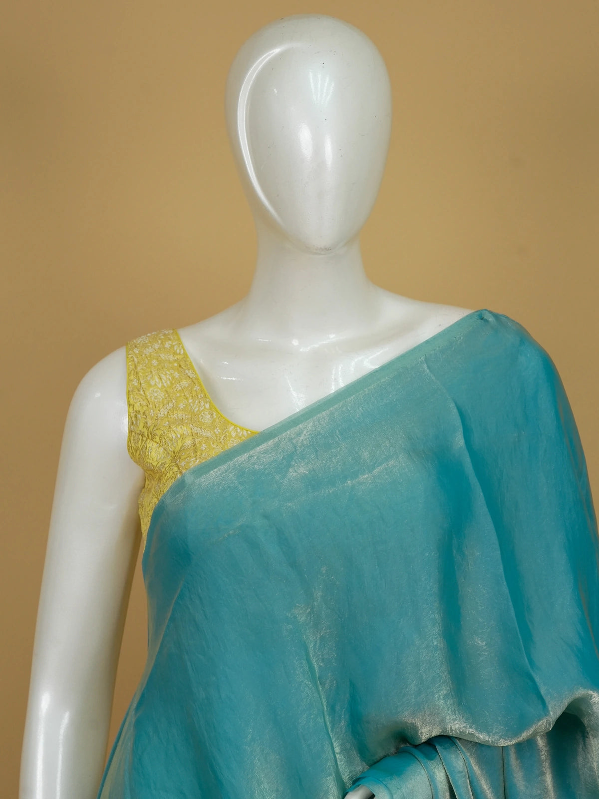 Turquoise blue shimmer tissue designer saree with printed floral-paisley contrast blouse