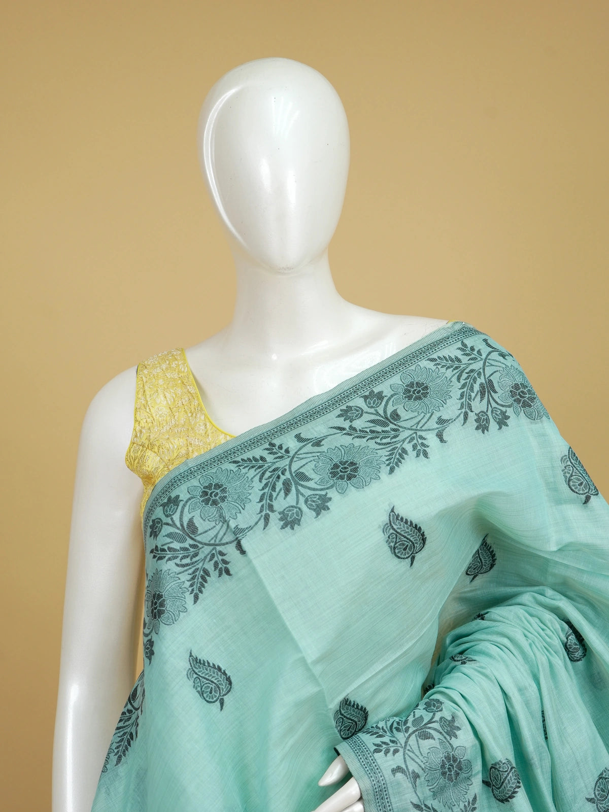Sea green linen cotton saree with dark teal paisley buttas, floral border and scenic peacock and deer pallu