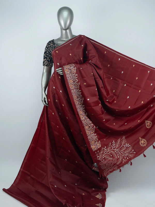Maroon semi raw silk saree with embroidered pallu, buta motifs and contrast black embroidered blouse