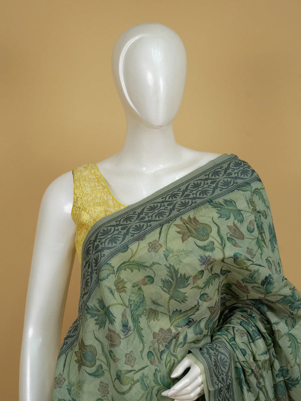 Sage green linen cotton saree with floral and bird print, grey floral border and Pattachitra-style pallu