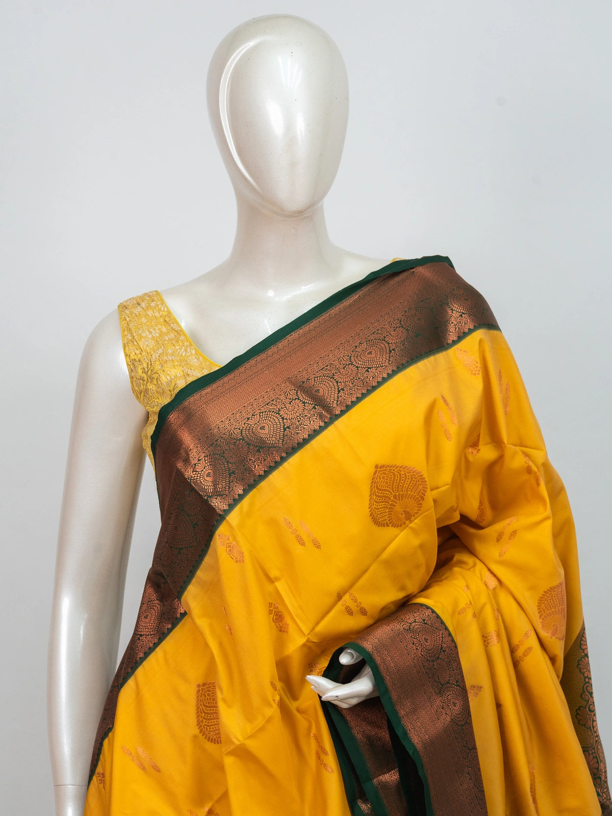Yellow Kanchipuram fancy silk saree with green contrast border and copper zari pallu
