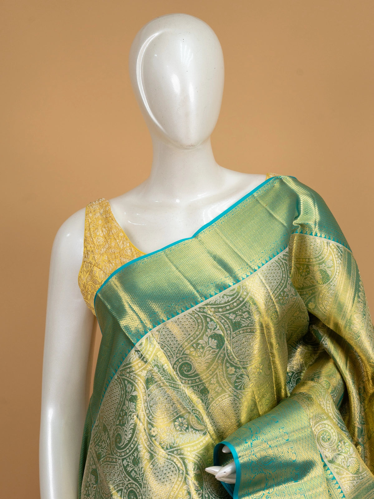 Green pure Kanchipuram silk saree with gold zari brocade body and contrast teal blue zari border