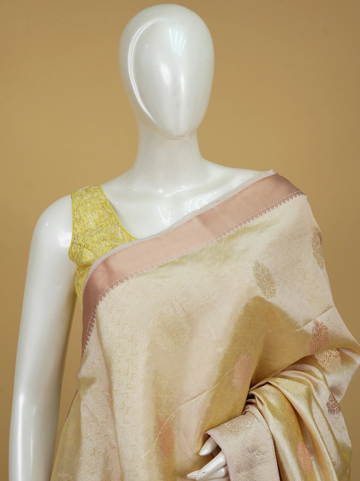 Cream gold semi tussar saree with woven floral zari buta and contrast peach border