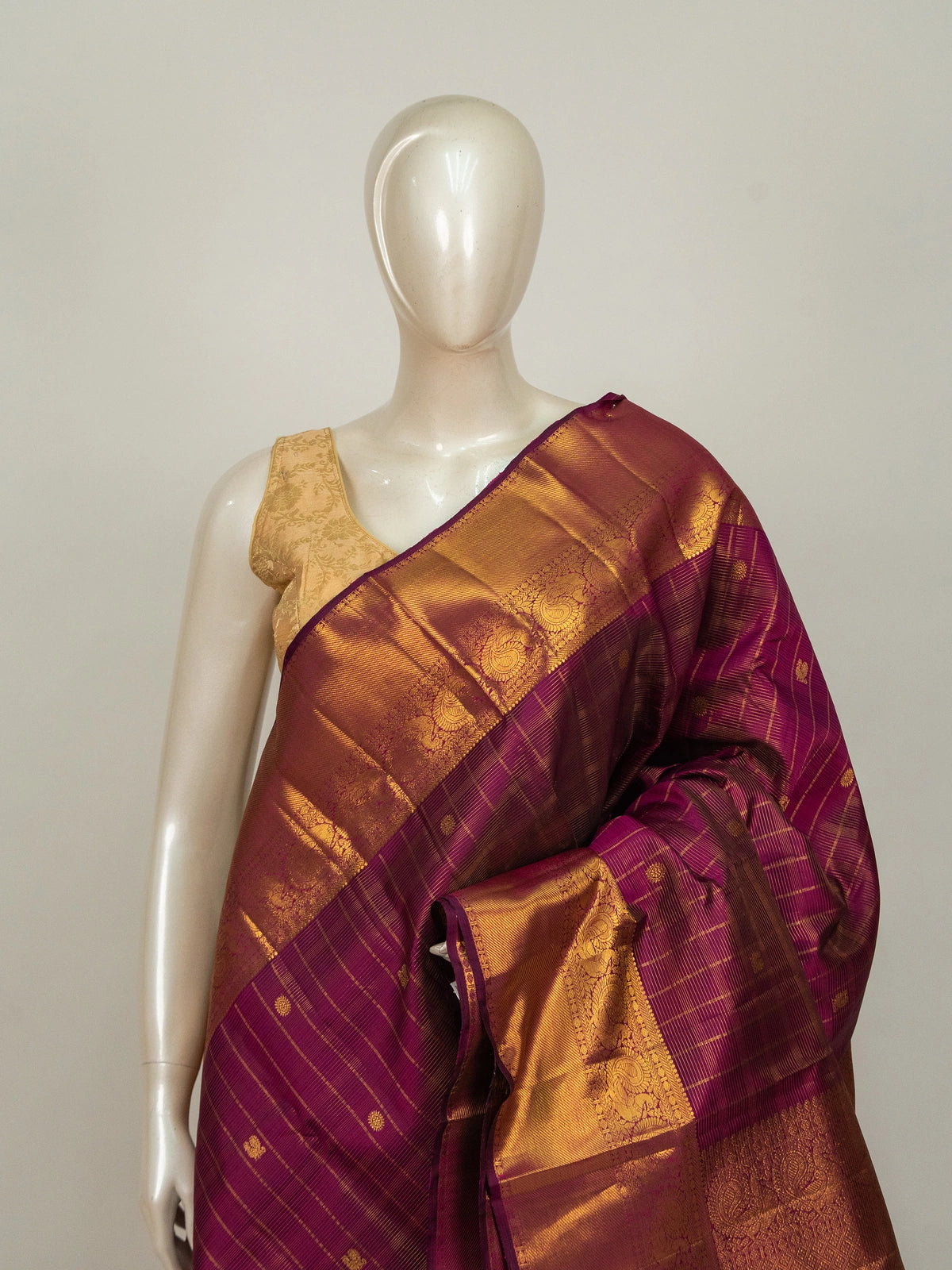 Magenta pure Kanchipuram silk saree with gold zari checks and contrast peacock-motif border