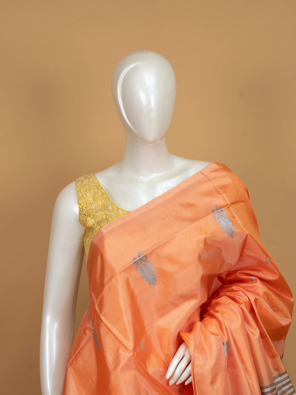 Peach orange banana silk saree with silver buttas and a contrast grey striped pallu
