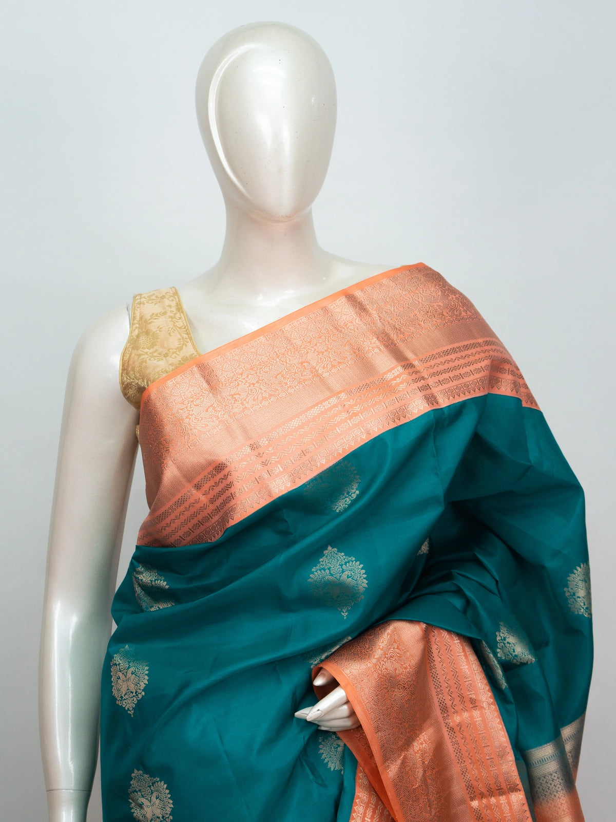 Teal Pure Kanchipuram Silk saree with copper contrast zari border and gold buttas