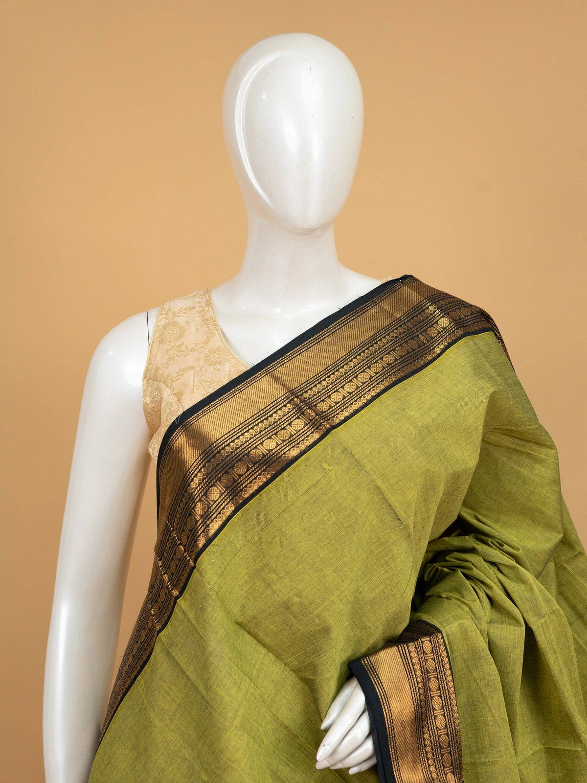 Mehndi green Chettinad cotton saree with black and gold zari border and striped yellow pallu