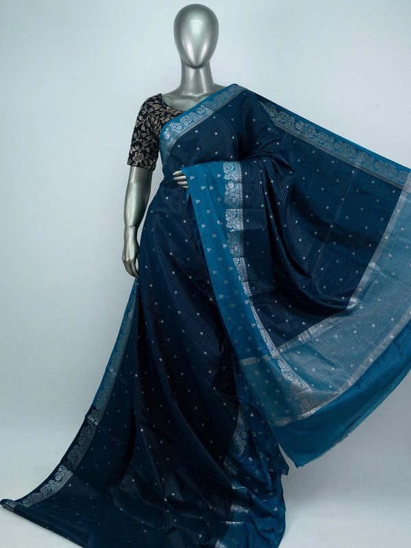 Teal blue semi raw silk saree with silver zari buttis and floral zari border
