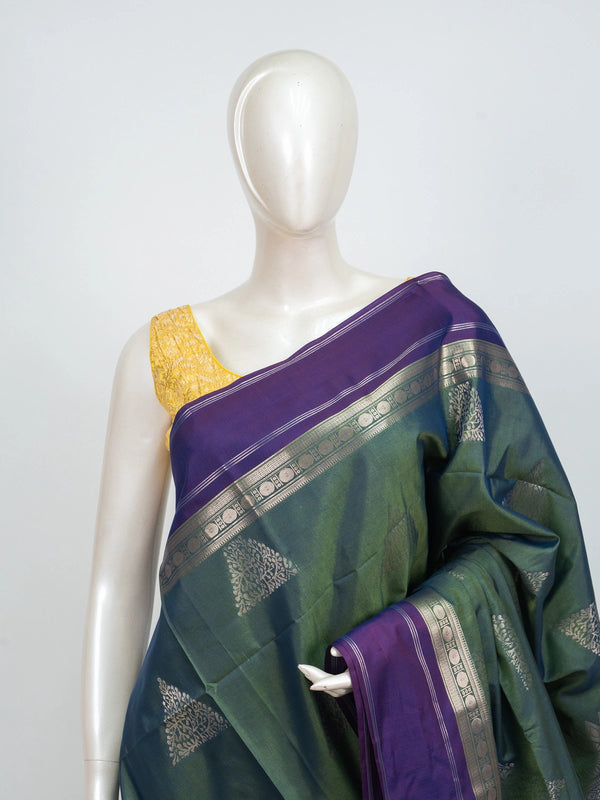Green Kanchipuram fancy silk saree with contrast purple silver zari border and triangular zari buttas