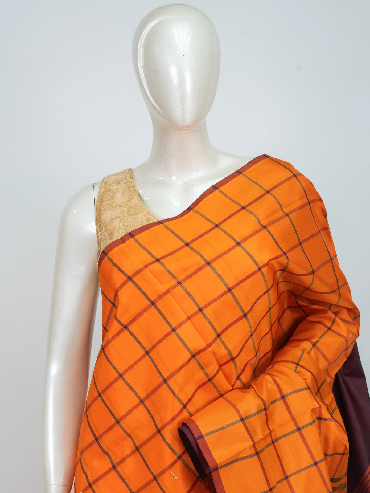 Orange checked banana silk saree with contrast maroon border and gold zari motif pallu