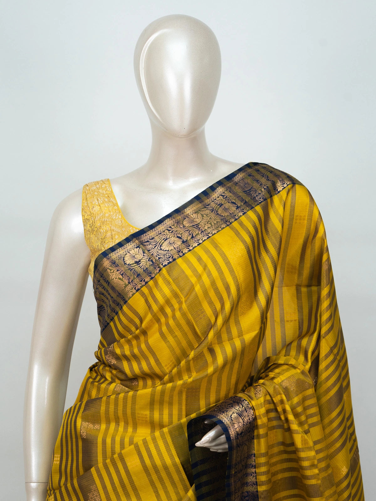Mustard yellow soft silk saree with navy blue gold zari border and floral pallu