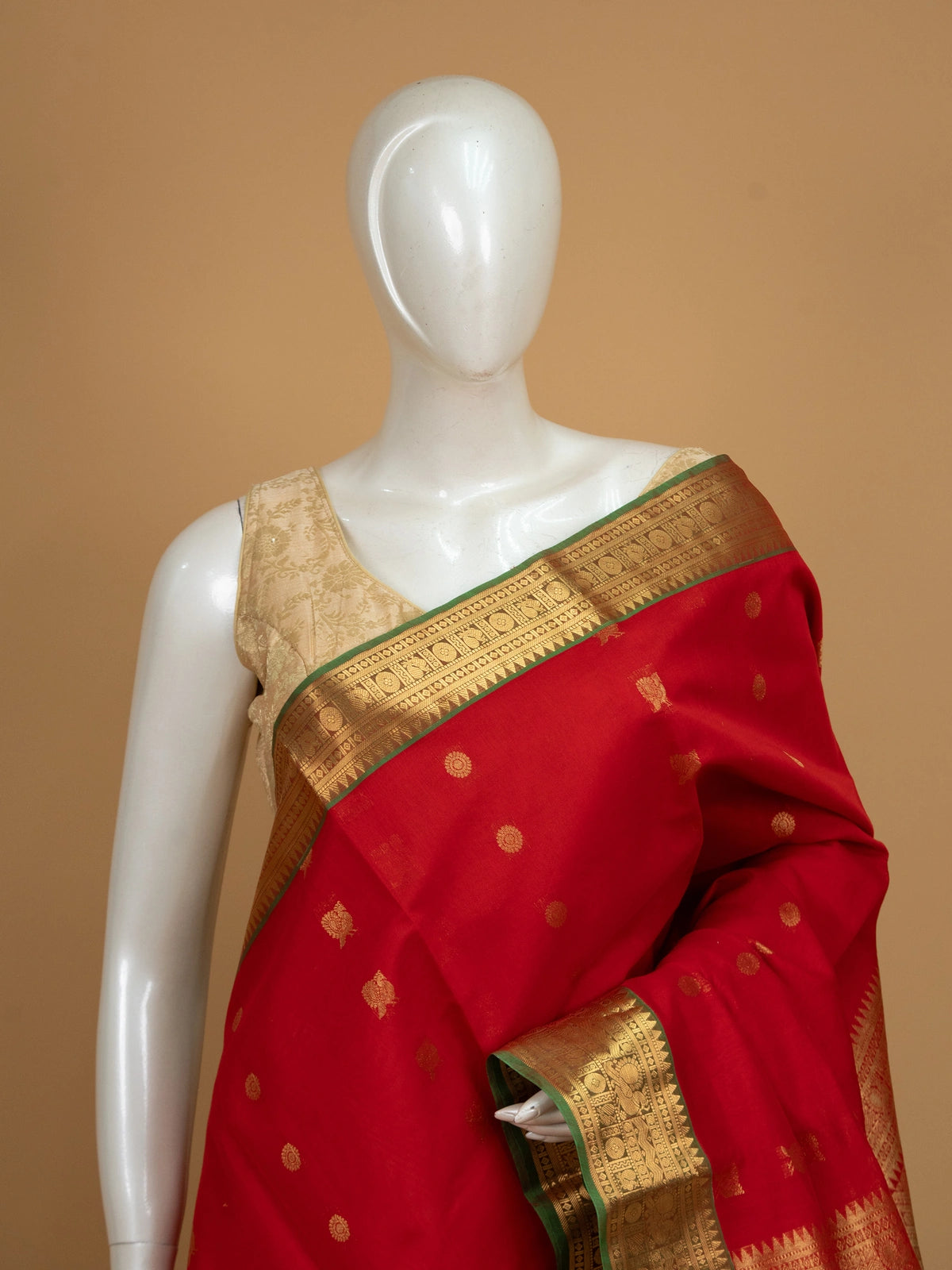 Red pure silk cotton saree with gold zari border, temple pallu, and woven buttas