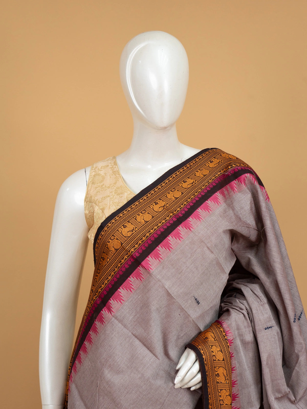 Grey Chettinad cotton saree with mustard and black contrast border, pink temple edging and woven animal motifs