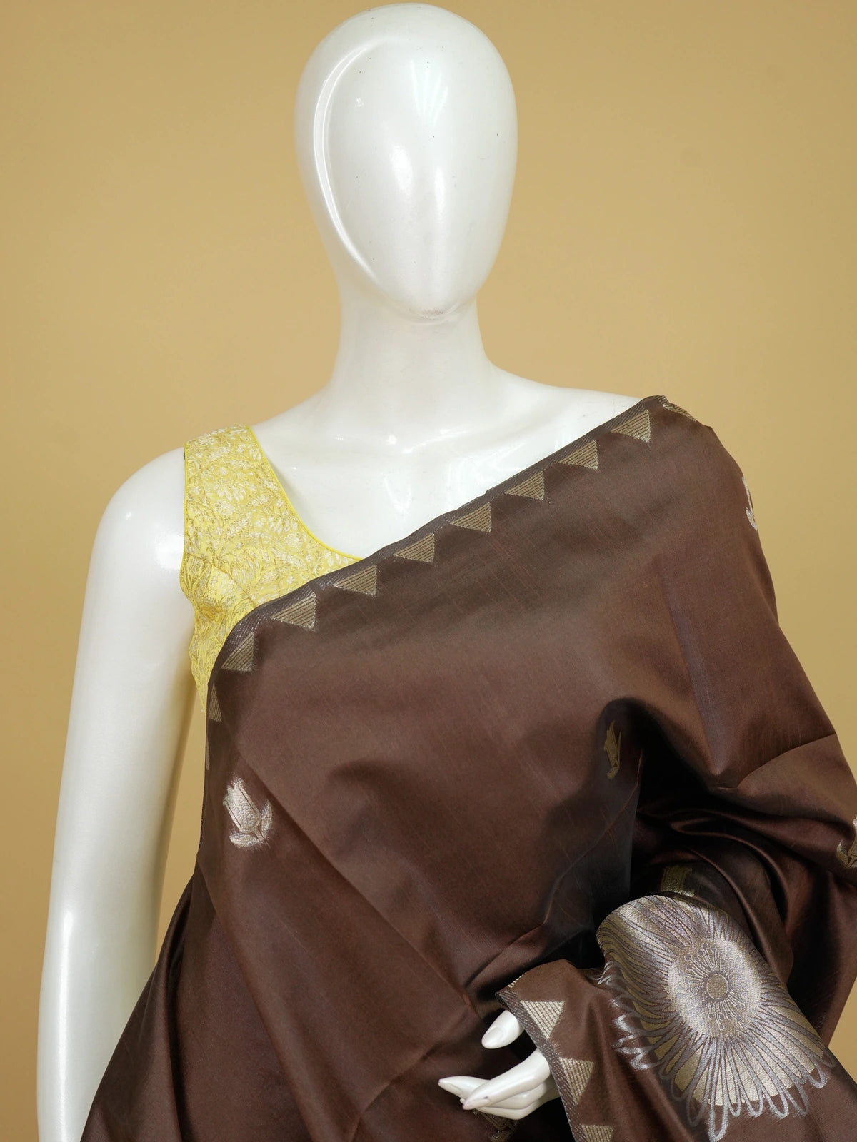 Brown semi tussar saree with gold and silver zari buttas, temple border and floral medallion pallu
