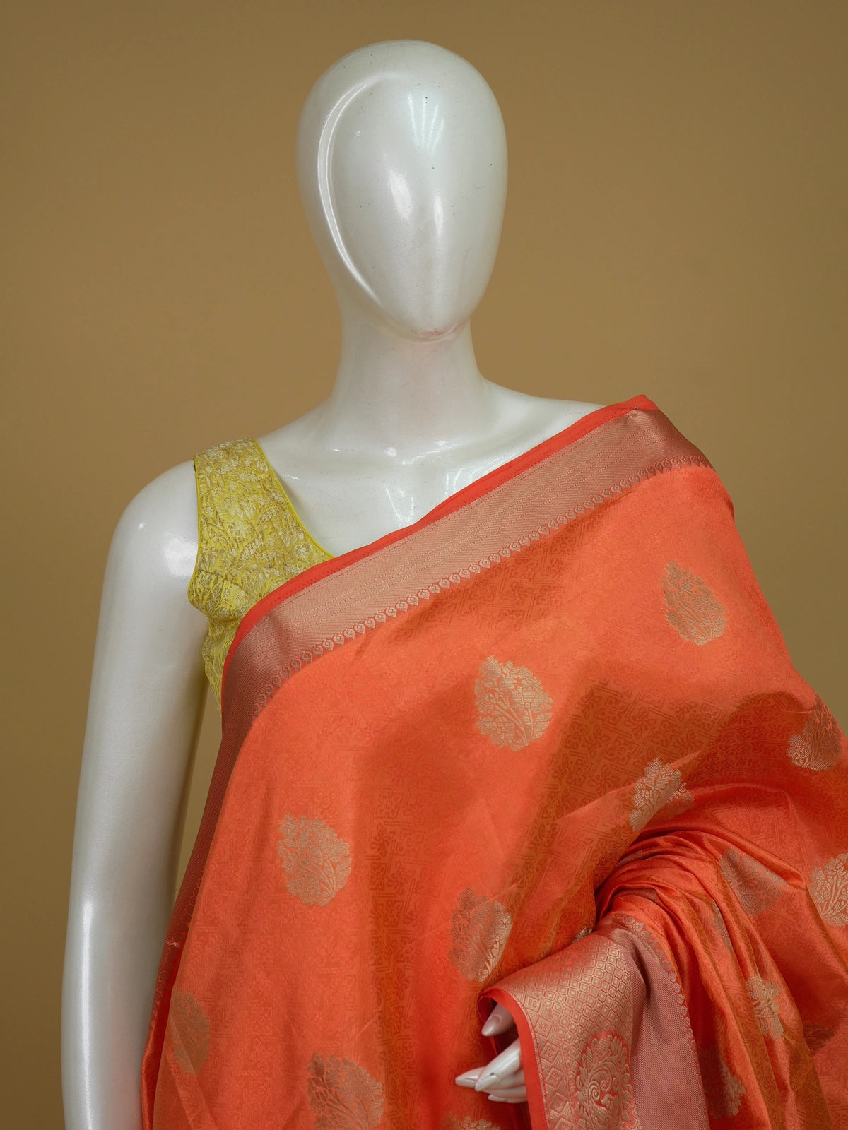 Orange semi tussar saree with gold zari floral buttas and ornate contrast zari border