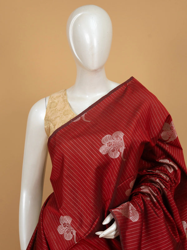 Maroon silk cotton saree with silver zari stripes, floral butta and contrast teal blue zari border