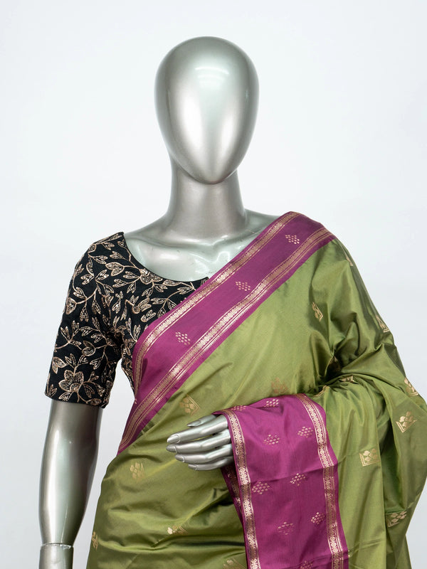 Mehndi green semi silk saree with magenta contrast border, gold zari buttas and woven pallu