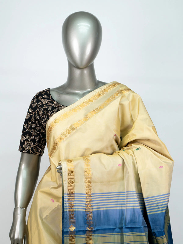 Cream and blue banana silk saree with gold zari border and contrast blue pallu