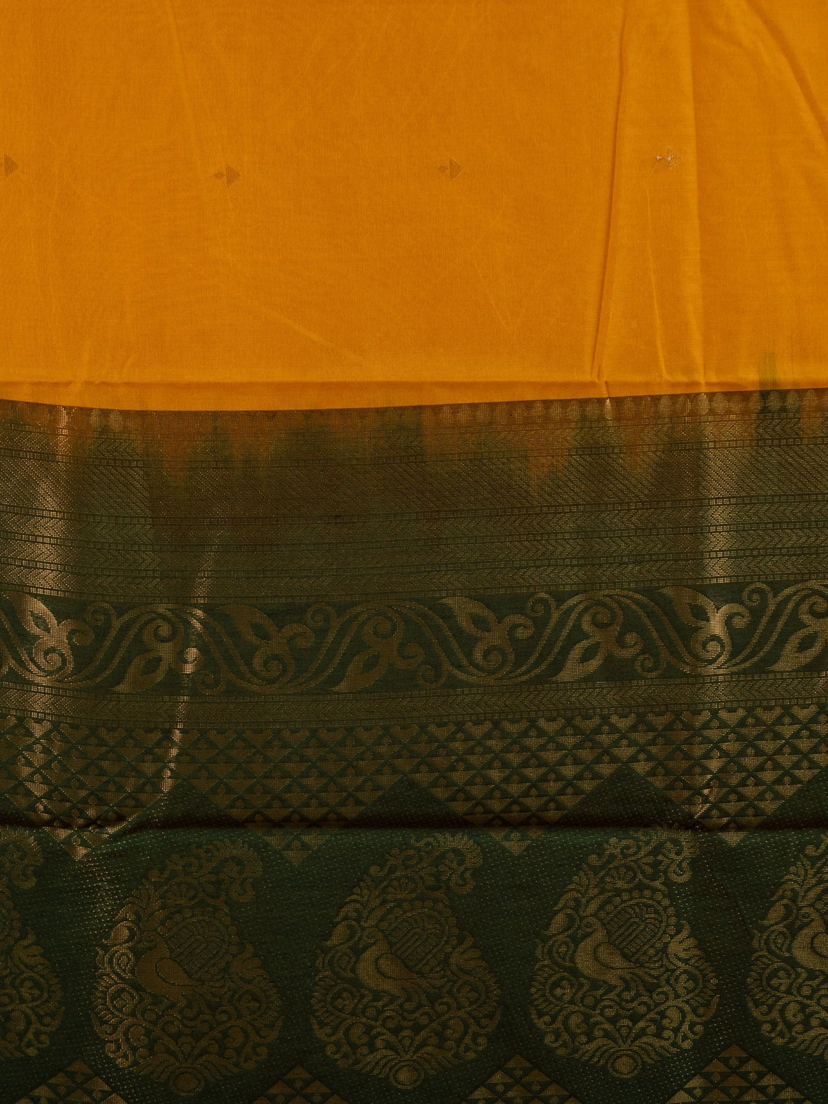 Mustard yellow silk cotton saree with green gold zari border and peacock pallu