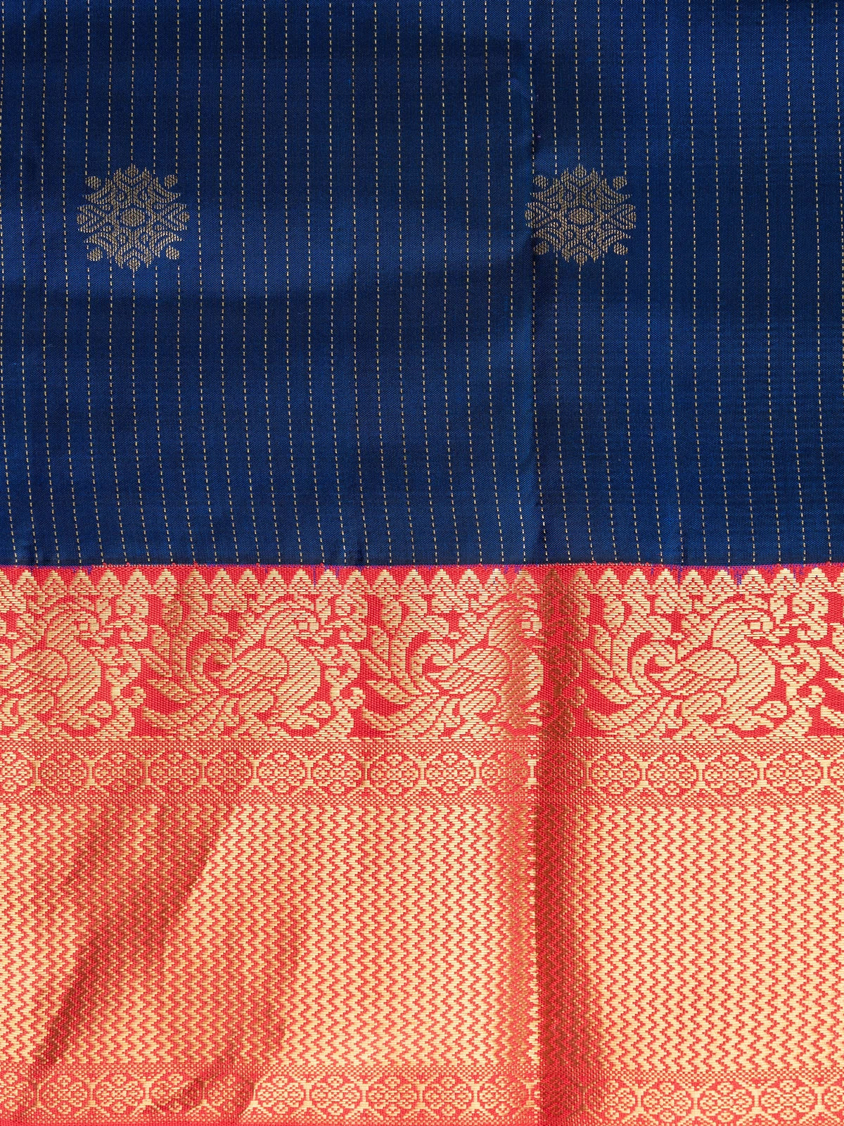 Navy blue pure Kanchipuram silk saree with gold zari stripes, floral buttas and contrast red gold zari border
