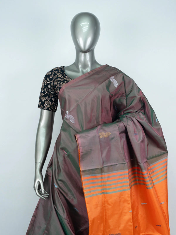 Grey and orange banana silk saree with dual-tone body, zari buttas and a striped contrast orange pallu