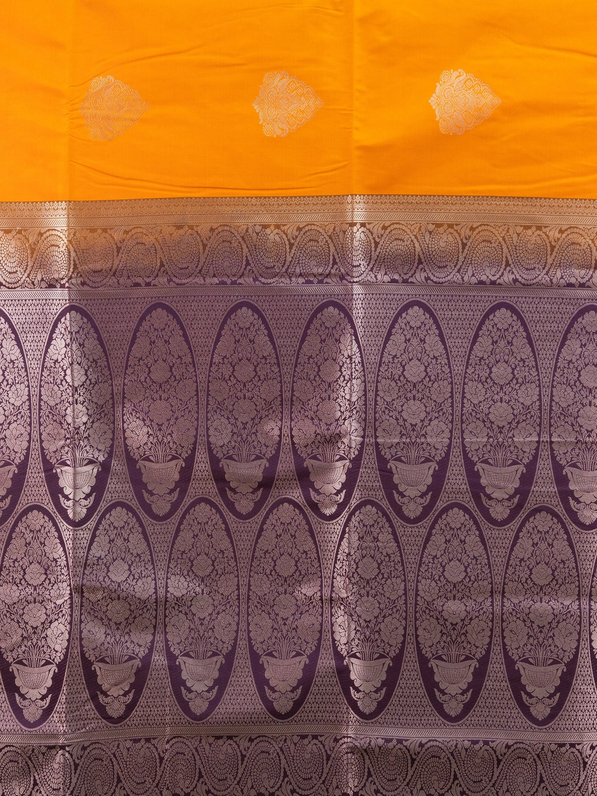 Mustard semi silk saree with contrast purple gold zari border, zari buttas, and ornate woven pallu